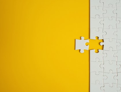 white-jigsaw-puzzle-on-yellow-background-team-business-success-or-picture-id1203219246.jpg