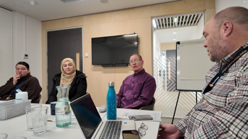 Tenants and staff at a Service Influence Group meeting